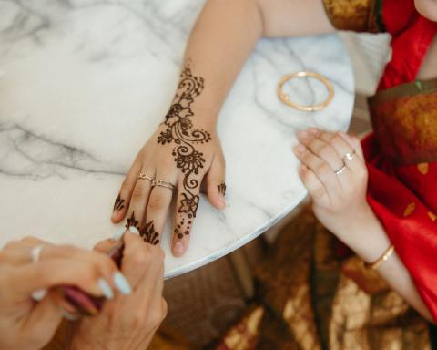 henna art being drawn on a hand
