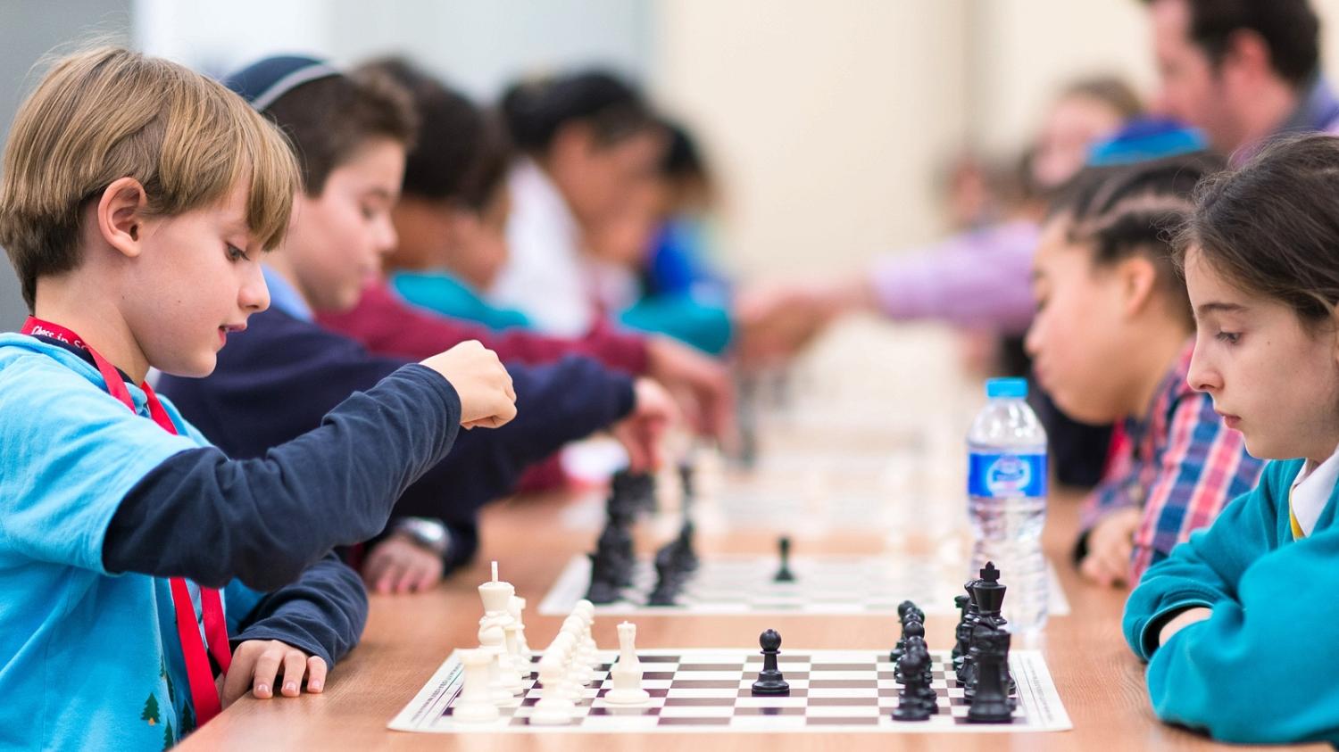 children playing chess tournament