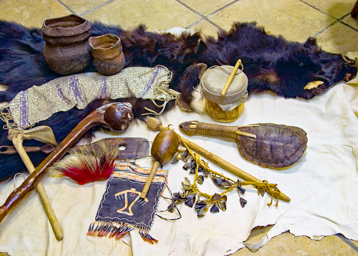 various Native American tools and animal pelts