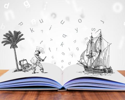 open book with drawings of a pirate and pirate ship; random letters floating in the air