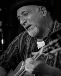 Tal Naccarato singing and playing guitar