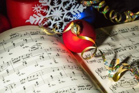 Christmas Ornaments and ribbon on a music book