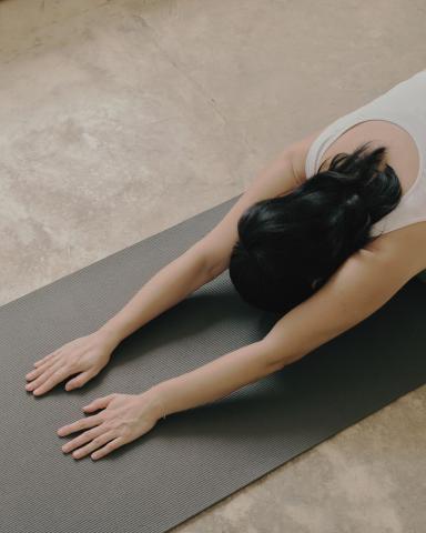 woman practicing yoga on mat