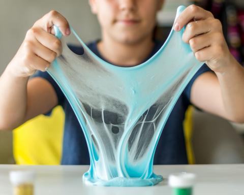 image of child pulling on blue slime