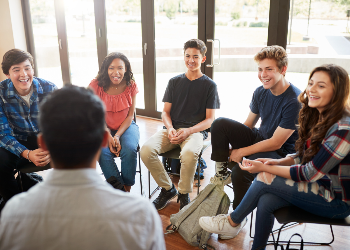 teenagers sitting in a group and talking