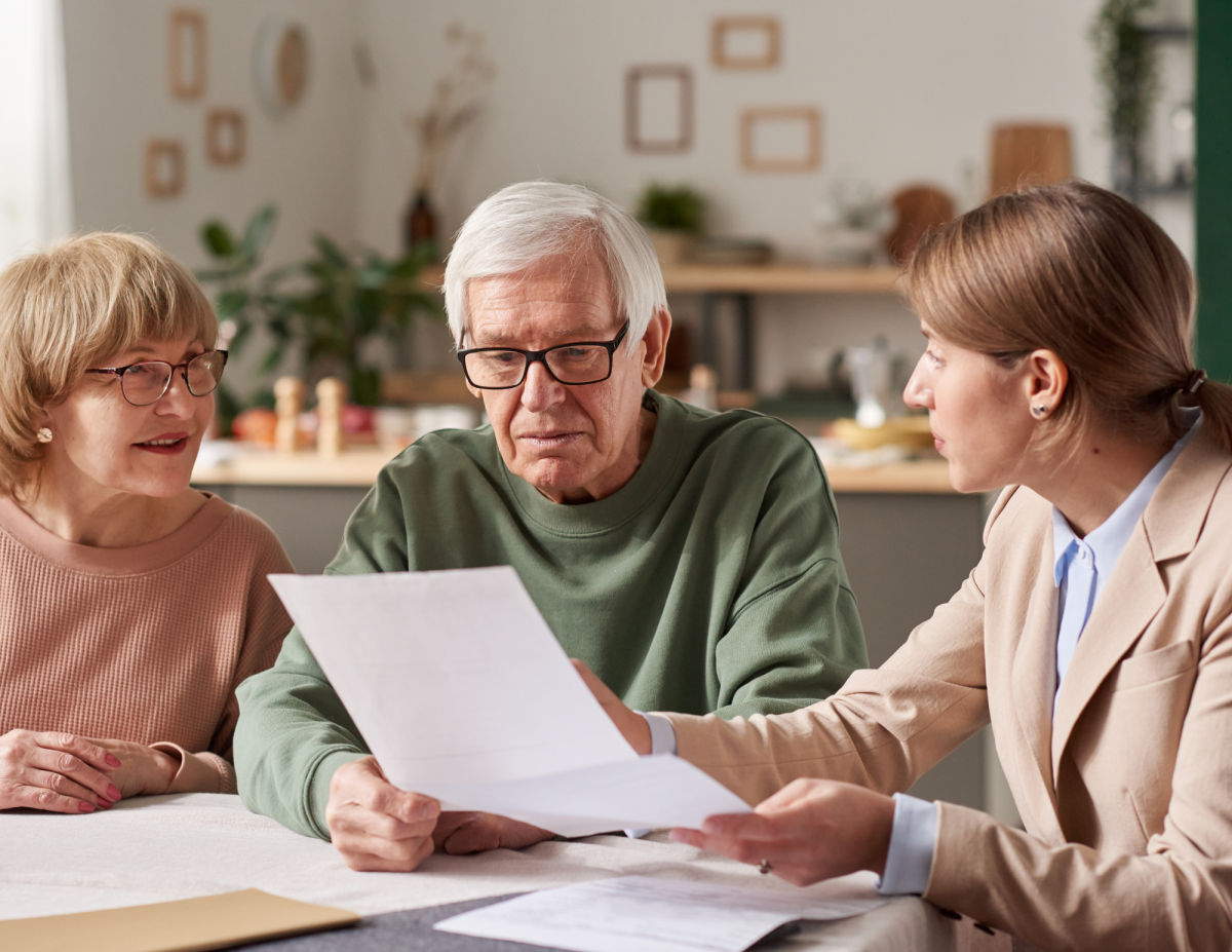 Adult speaking with seniors about paperwork