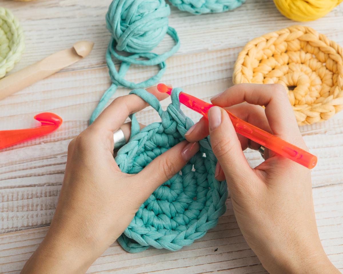 image of two hands crocheting