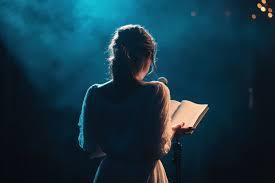Girl reading on stage