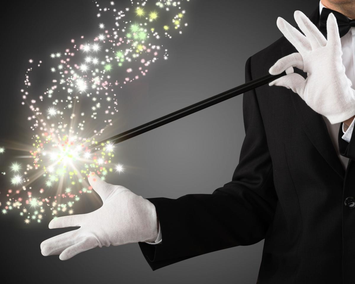 image of magician holding a magic wand