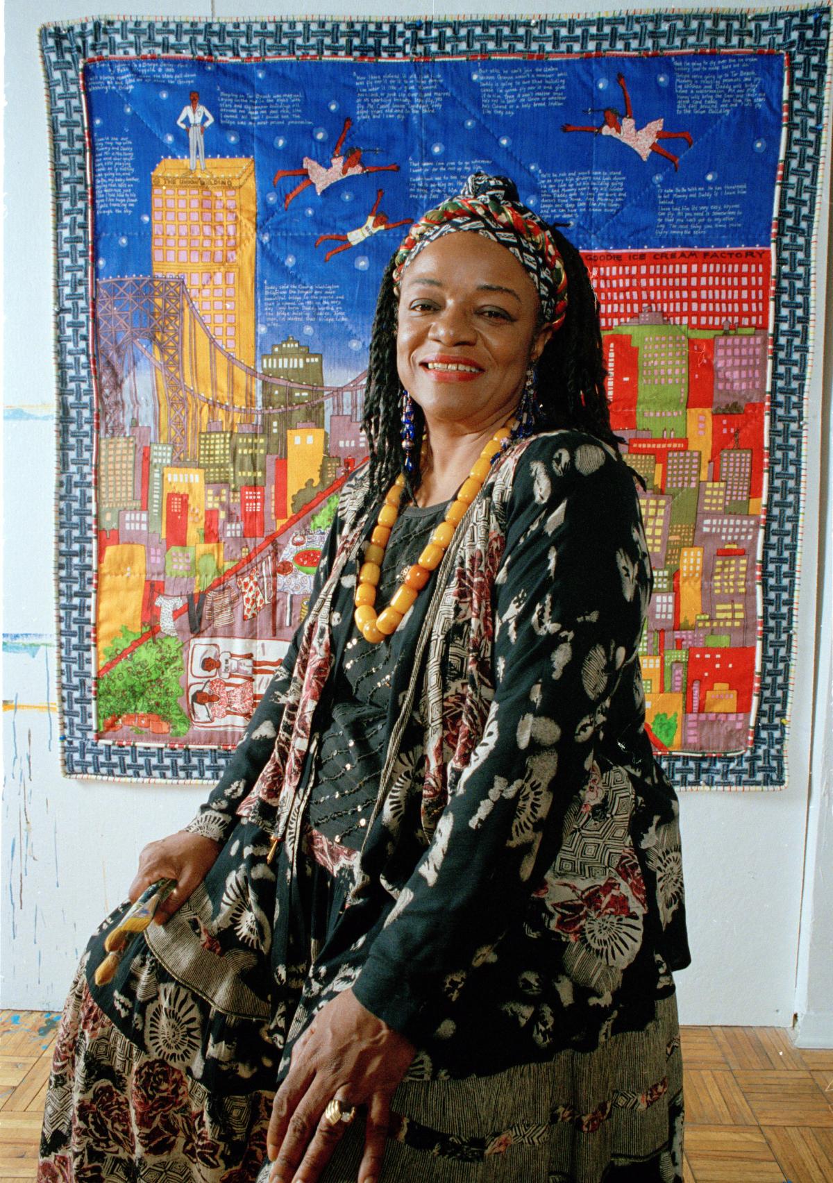 Artist Faith Ringgold in front of her art