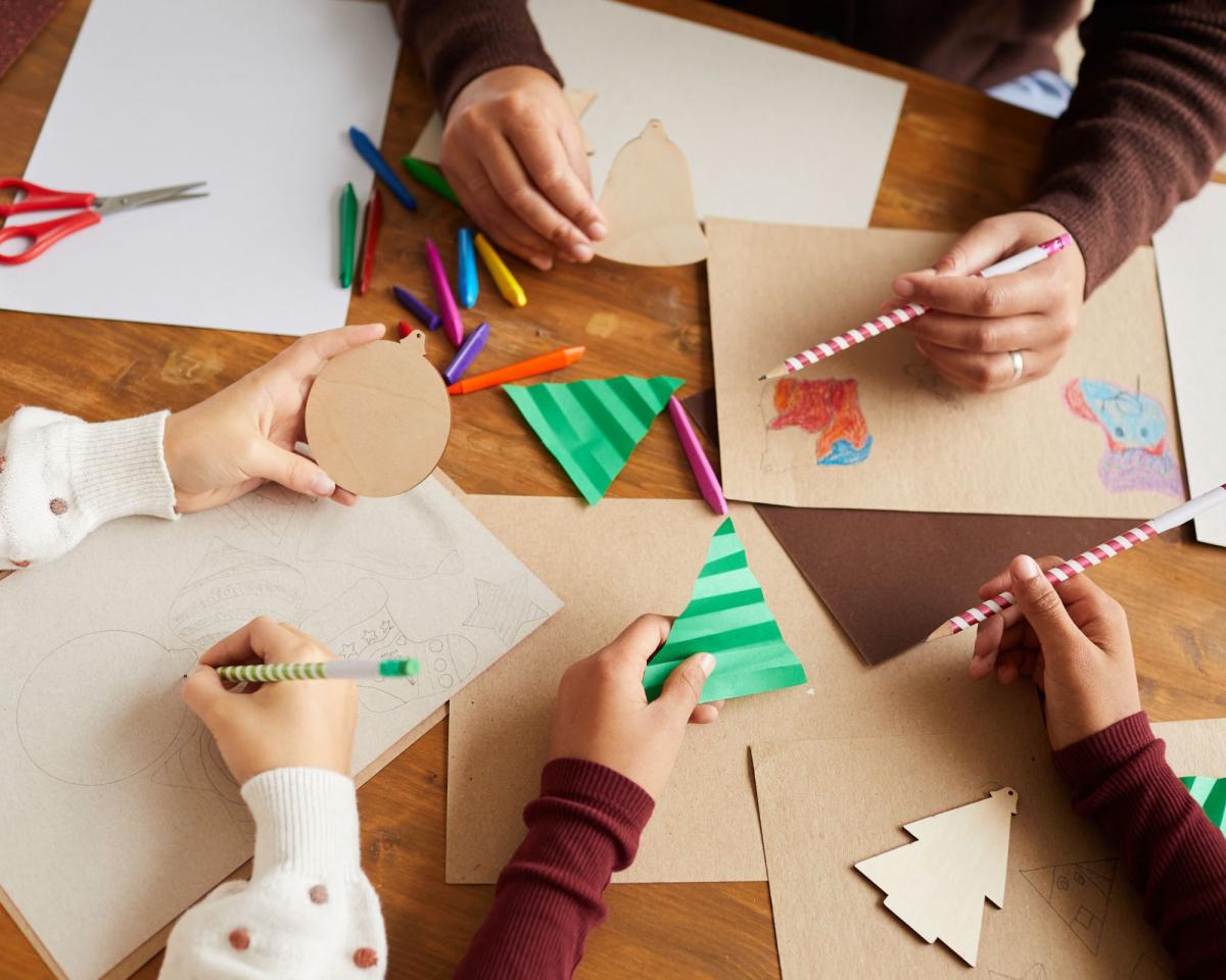 image of people hand making holiday cards