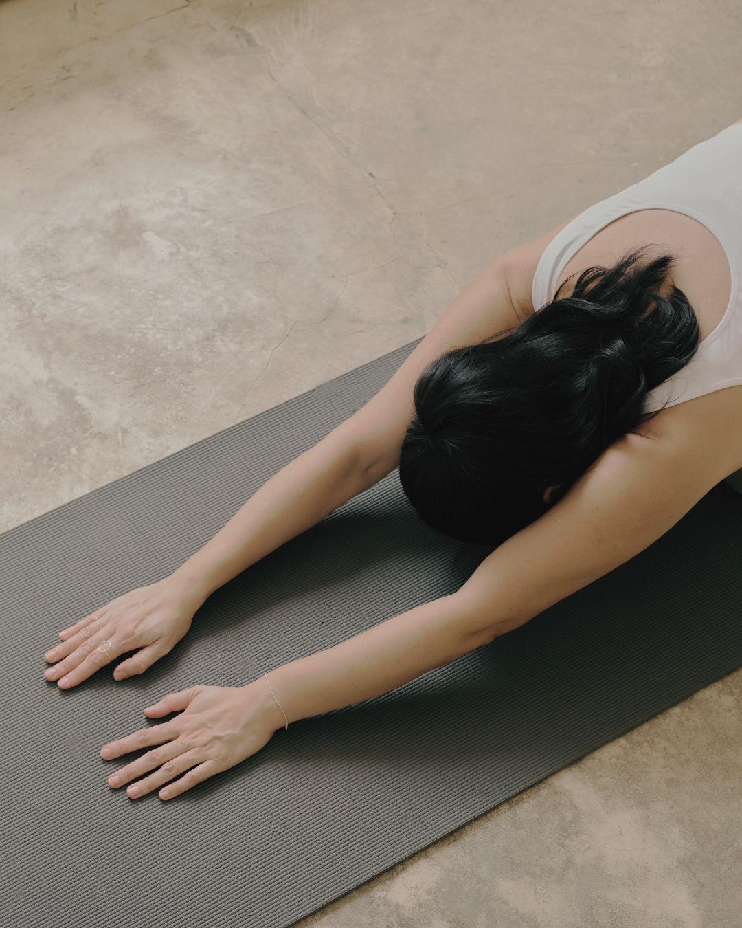 woman practicing yoga on mat