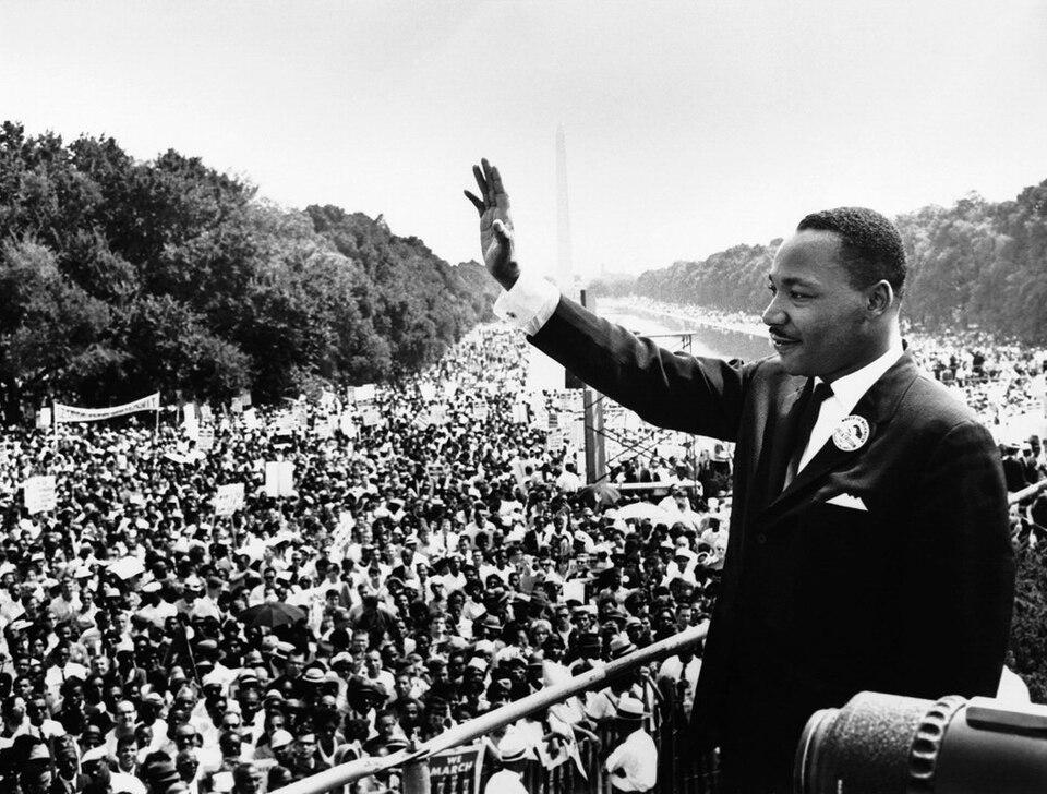 Dr. Martin Luther King waving to crowd on National Mall