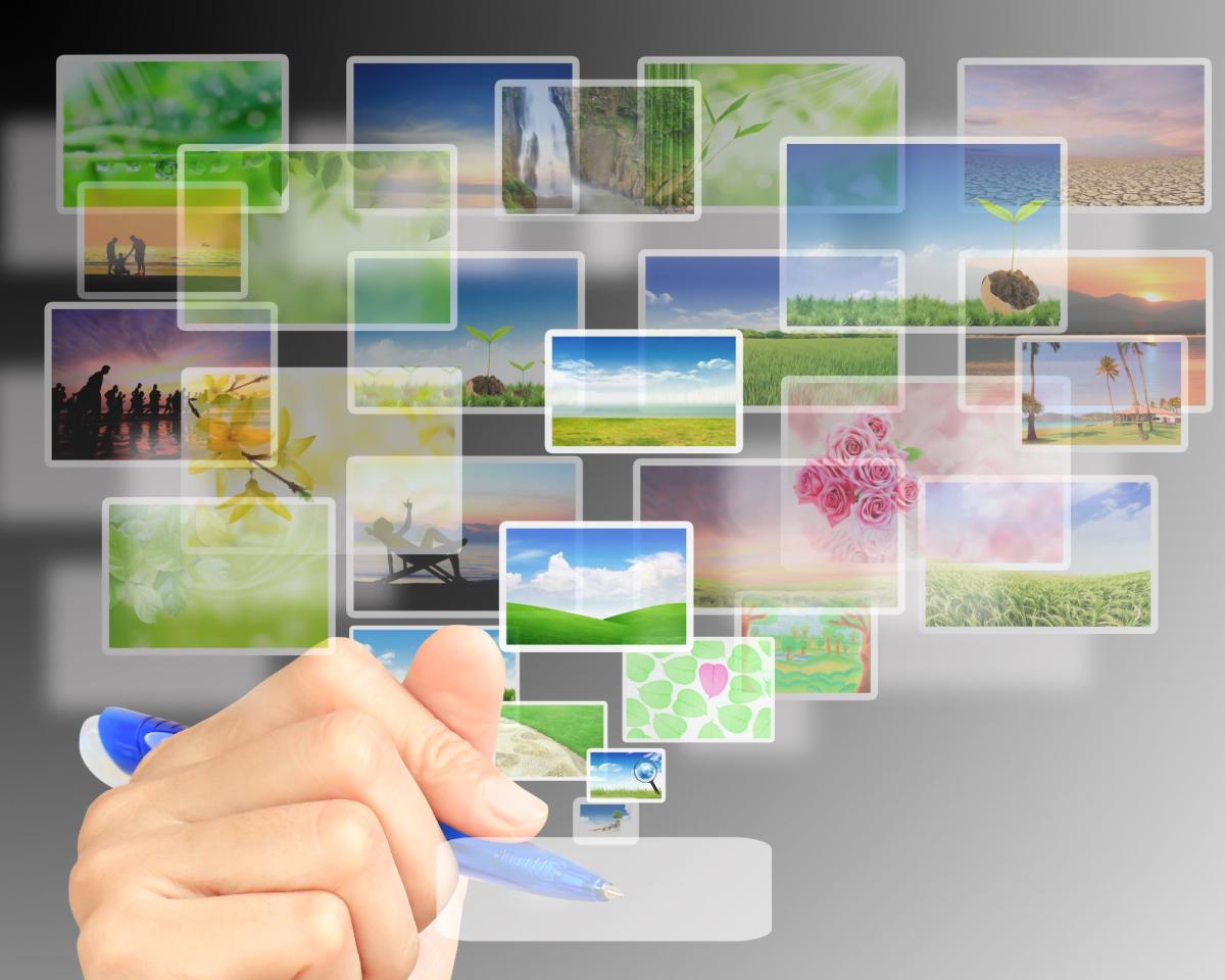 image of images and a hand holding a pen to organize images